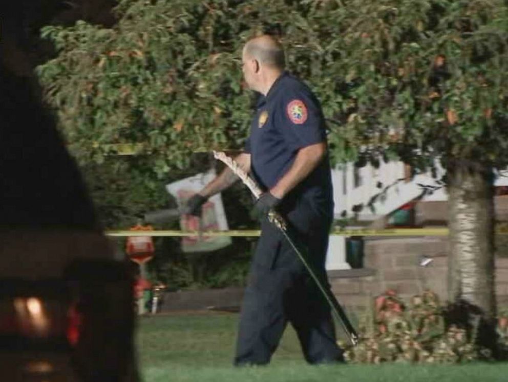PHOTO: A police officer removes a samurai sword from a Long Island, New York, home after police fatally shot a man who confronted them with the weapon Friday.