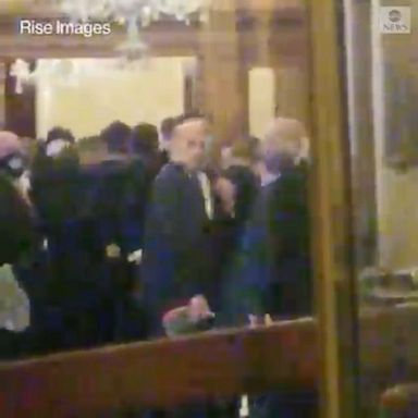 Video captured on Jan. 6 shows members of Congress inside the Capitol as rioters pushed against a barricaded door.