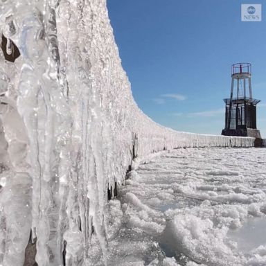 Icicles formed along a pier at Chicago's North Avenue Beach amid winter weather and icy waves on Lake Michigan.