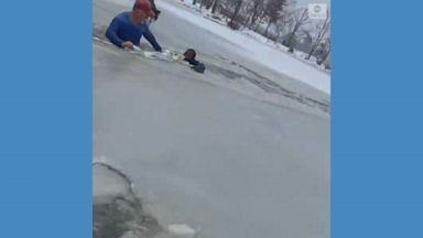 An 11-year-old boy was safely rescued from an icy pond after being spotted by a dog walker.