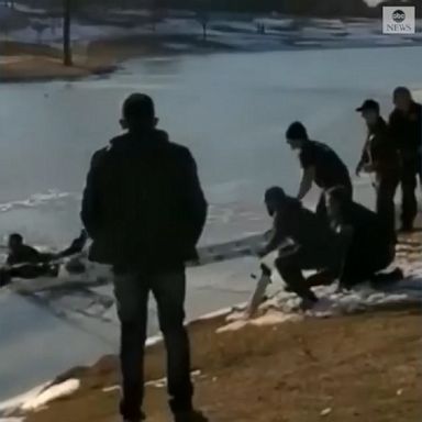 A police officer and firefighter saved a man and woman who plunged into a frozen pond 20 feet from shore in Irving, Texas.