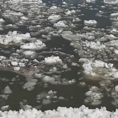 As parts of the Midwest and South thaw from a deep freeze, an ice jam is seen lazily flowing downstream toward St. Louis.