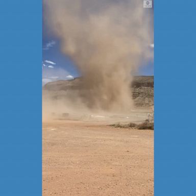 A driver in Utah got up close to a large dust devil whirling across a farm.