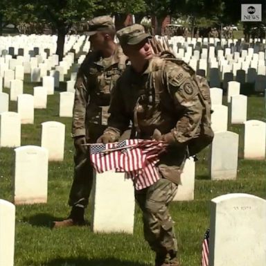 U.S. military service members placed flags at gravestones in Arlington National Ceremony in Virginia to mark Memorial Day.