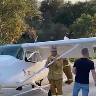 Emergency workers removed signs along an off-ramp to make way for the wings of an aircraft that made an emergency landing on Highway 101 in California. No injuries were reported.