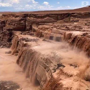 Muddy water poured down Arizona's Grand Falls following heavy rainfall in the region.