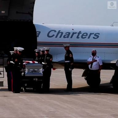 Service members line the streets as the body of Cpl. Humberto Sanchez, a 22-year-old U.S. Marine killed in the Aug. 26 blast in Afghanistan, is returned to his hometown for his funeral.