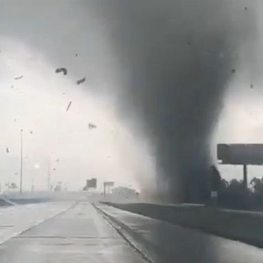 A driver captured dramatic footage of a tornado tearing across an interstate in Orange, Texas.