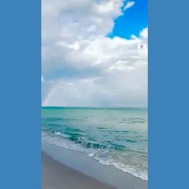 A stunning double rainbow arched across the sky above Surfside Beach, Florida.