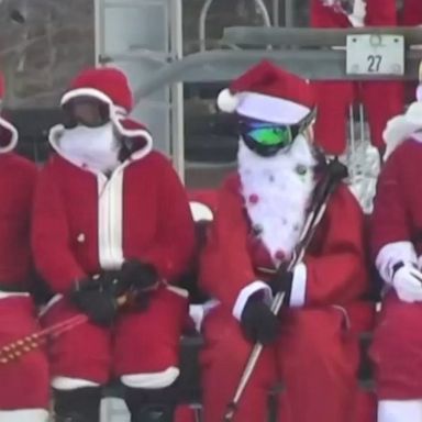 More than 230 skiing and snowboarding Santas took to a western Maine resort to raise money for charity.