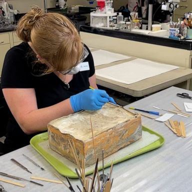 A time capsule estimated to be more than 130 years old, unearthed from the base of a statue of Confederate Gen. Robert E. Lee, was opened Wednesday in Richmond, Virginia.