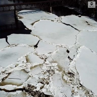 Drone footage captured large chunks of ice floating down the Aroostook River in Maine. 