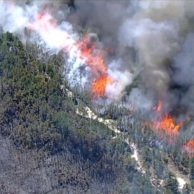 The fire has burned at least 12,000 acres and has forced the closure of nearby trails, roads and campgrounds. 