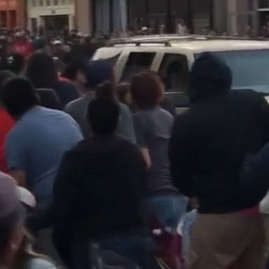 Several people, including two officers, were injured after a car drove through an intertribal ceremonial parade in Gallup, New Mexico, on Thursday, police said.