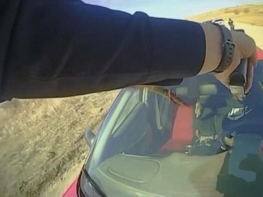 WATCH: Officer clings to car