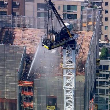 A crane caught fire and partially collapsed off a high-rise building in midtown Manhattan during Wednesday morning's commute, according to officials.