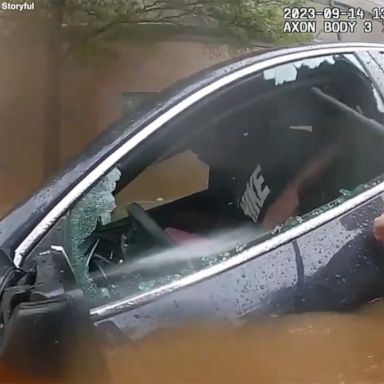 VIDEO: Police smash car window to save driver trapped in floods