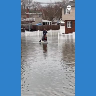 VIDEO: Man paddles kids to school on flooded Long Island street