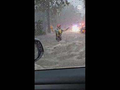 WATCH:  Terrifying moment driver gets trapped in SUV as street floods around him