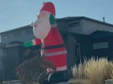 WATCH:  Giant inflatable Santas take over Utah neighborhood