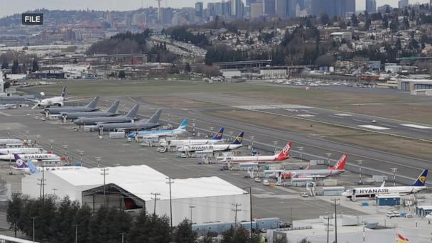 Unruly plane passenger tried to open emergency door, officials say