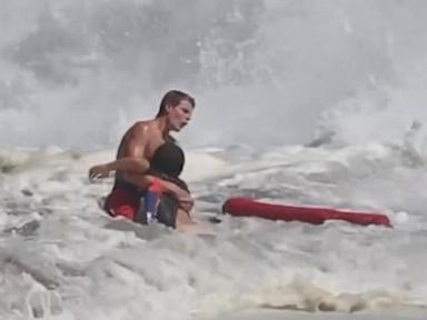 WATCH:  Lifeguard fights to rescue boy caught in high surf