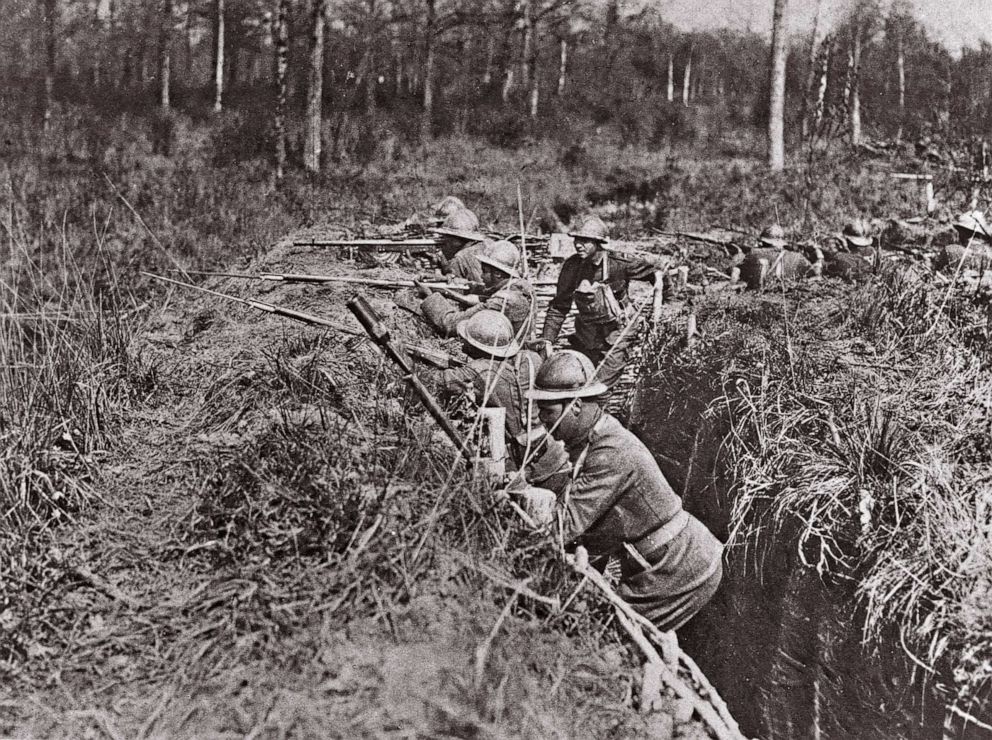 PHOTO: African American soldiers (and one of their white officers) of the 369th Infantry Regiment known as "Harlem Hellfighters," receive training in the trenches of the Western Front in France during World War I, ca. 1917.