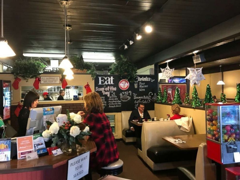 PHOTO: Dwayne Clark, CEO of Aegis Living, (man in booth) has been a regular with his wife (sitting across from him) at the Brief Encounter Cafe in Bellevue, Washington for eight years. 