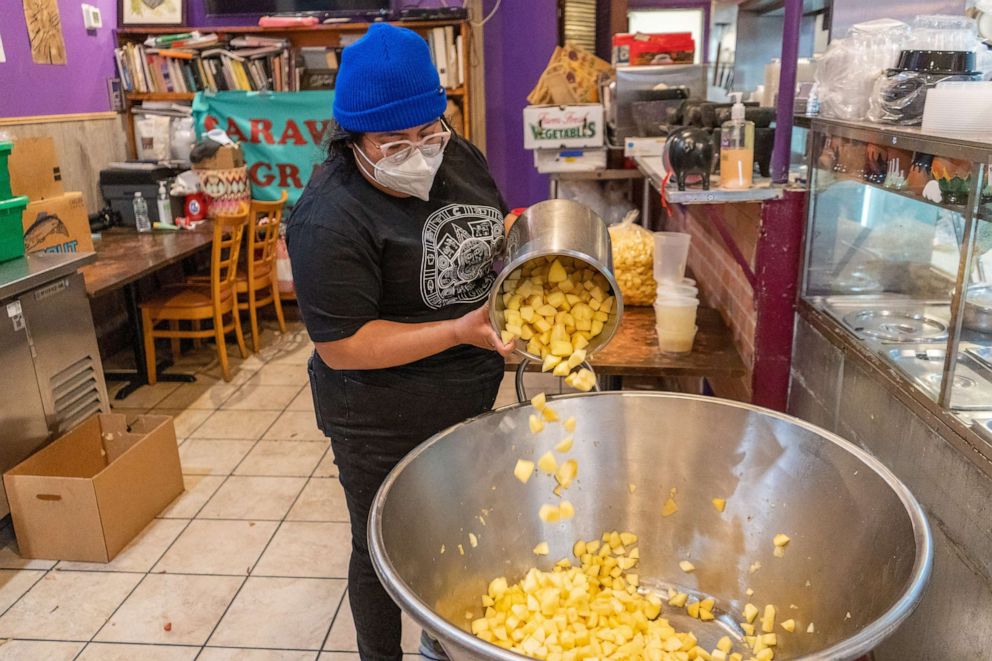 PHOTO: Yajaira Saavedra, Mutual Aid Coordinator for La Morada, pouring apples into a bowl to make 150 servings of applesauce.