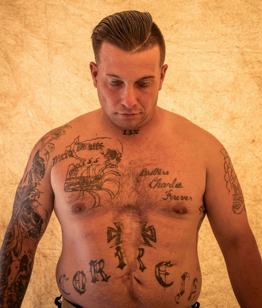 PHOTO: Eddie Correia, 36, an inmate from Warner Creek Correctional Facility, working as a firefighter, shows his tattoos as he poses for a photograph, on the sidelines of the Brattain Fire in Paisley, Ore., Sept. 21, 2020.