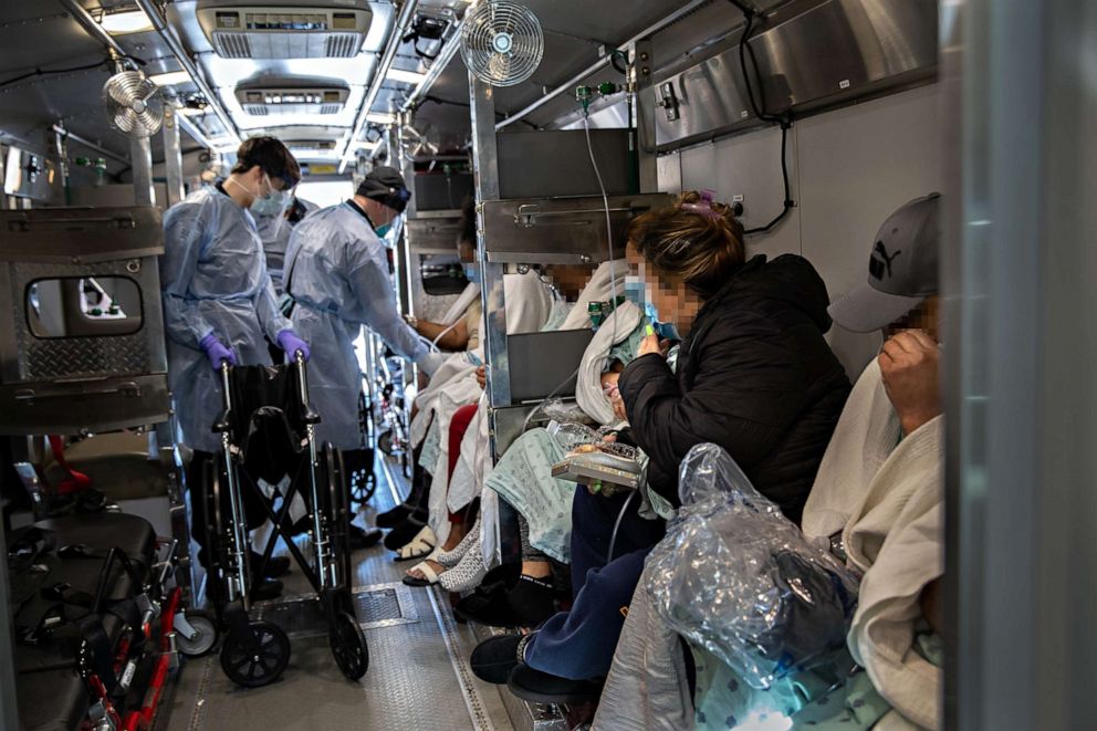 PHOTO: Medics and hospital workers prepare to lift a patient onto a hospital stretcher outside the Montefiore Medical Center Moses Campus, on April 7, 2020, in the Bronx borough of New York City.