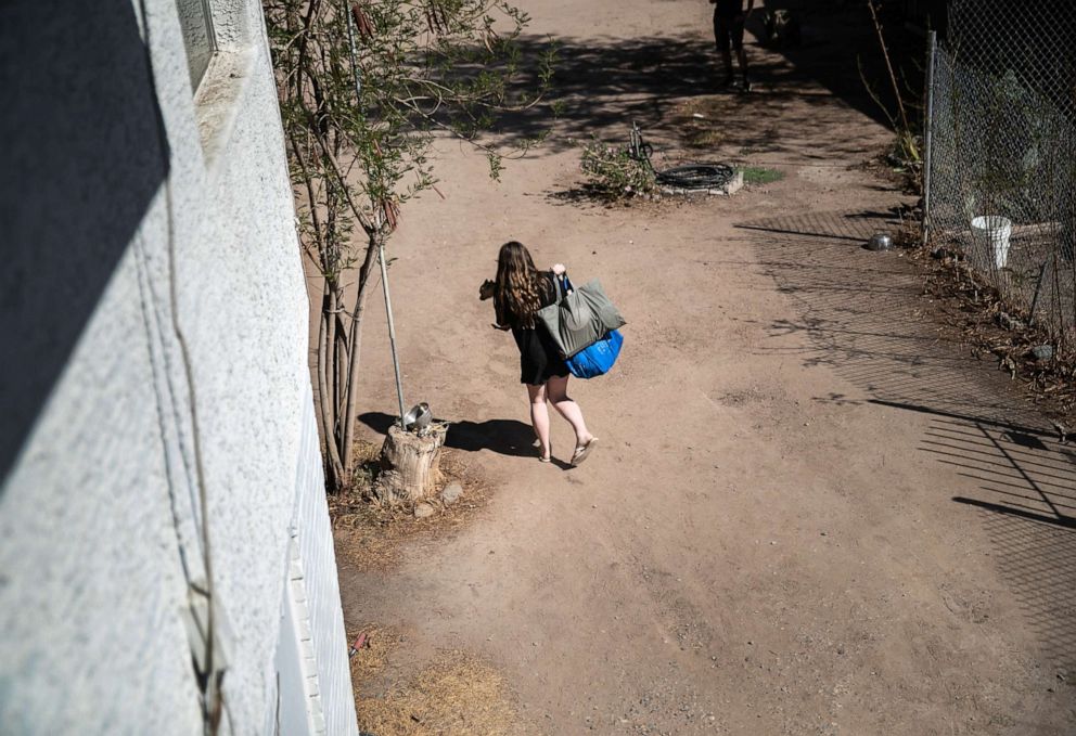 PHOTO: A child carries a pet from her apartment after her family was evicted for non-payment of rent on Sept. 30, 2020, in Phoenix, Arizona.