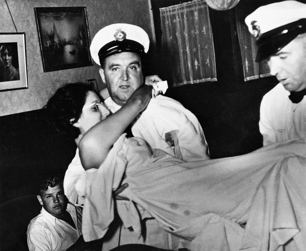 PHOTO: Hospital attendants remove a woman from an apartment where illegal abortions were performed, in San Francisco, Aug., 1935.