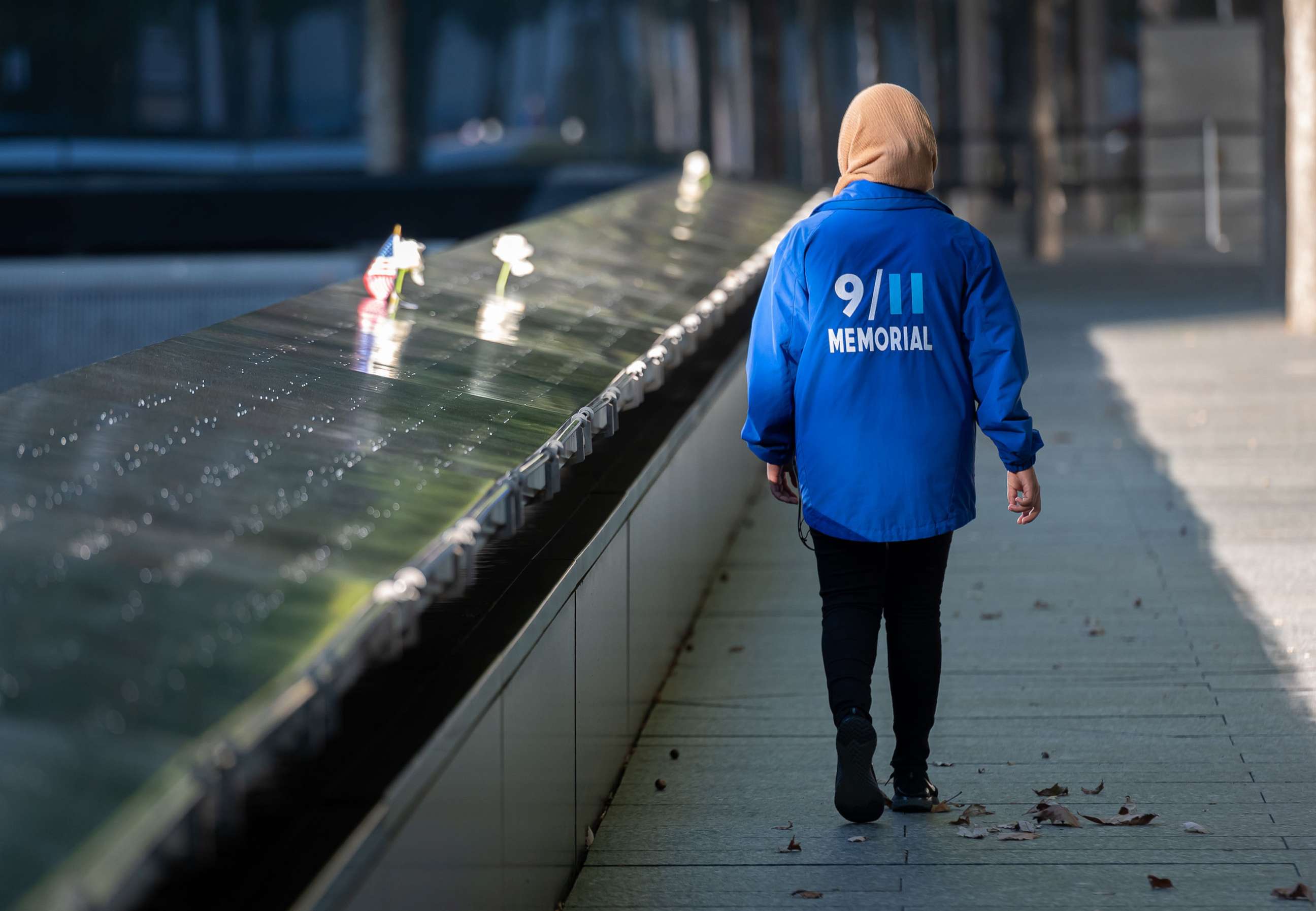 PHOTO: A person walks at the 9/11 Memorial & Museum in World Trade Center as the city continues Phase 4 of re-opening following restrictions imposed to slow the spread of coronavirus in New York, Sept. 30, 2020.