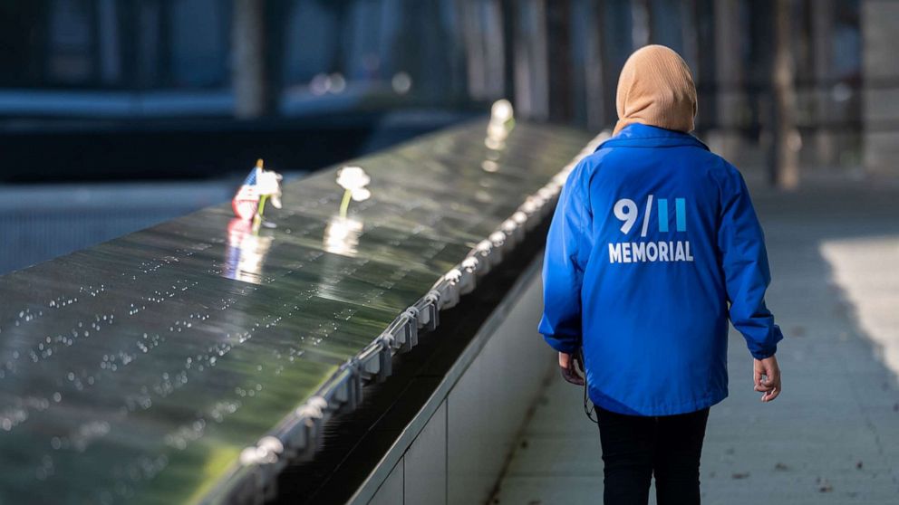 PHOTO: A person walks at the 9/11 Memorial & Museum in World Trade Center as the city continues Phase 4 of re-opening following restrictions imposed to slow the spread of coronavirus in New York, Sept. 30, 2020.