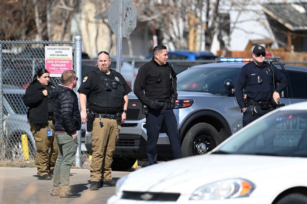 PHOTO: Police officers secures students parking area of Denver's East High School after a shooting at the school, March 22, 2023.