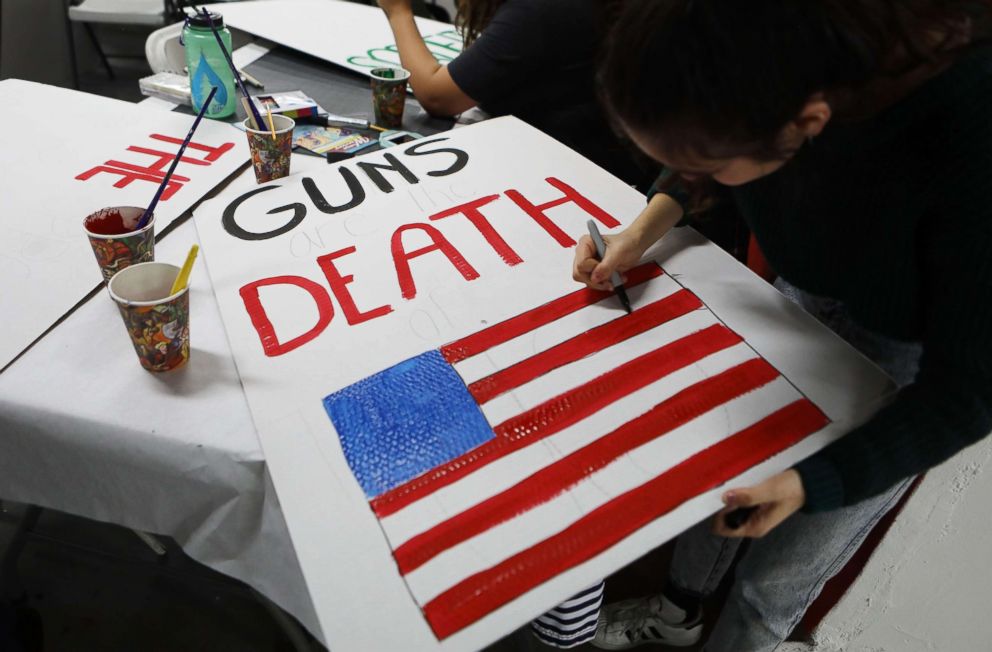 PHOTO: A student paints a sign to be carried at the upcoming March for Our Lives on March 22, 2018 in Los Angeles. 