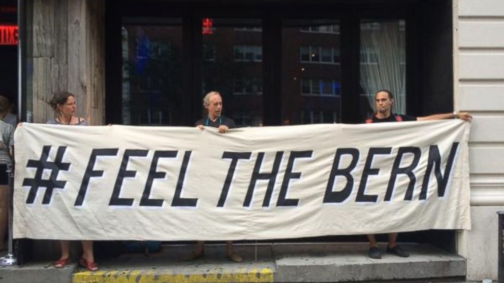 PHOTO: Supporters hold a #feelthebern sign outside the Bernie Sanders NYC event on July 29, 2015.