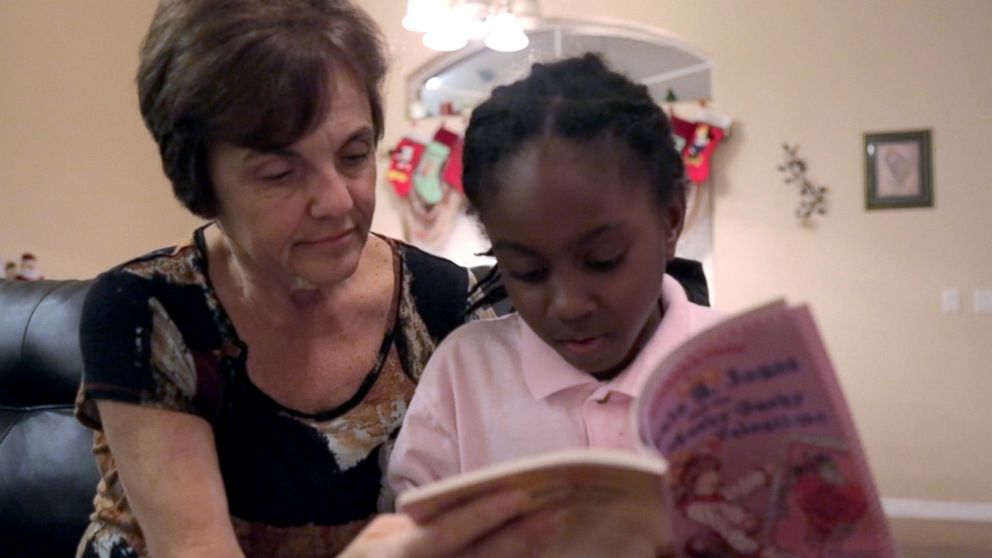 PHOTO: Janet Sylvester reads to one of her five foster children.
