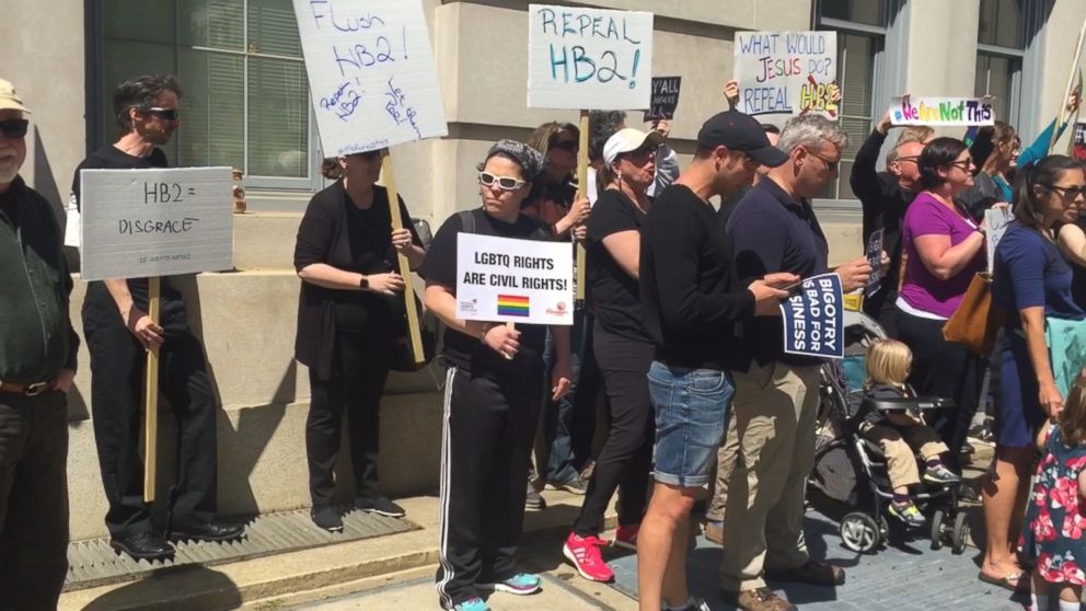 Opponents of a law that limits anti-discrimination policies for lesbian, gay and transgender people are seen in Raleigh, N.C., April 11, 2016. 