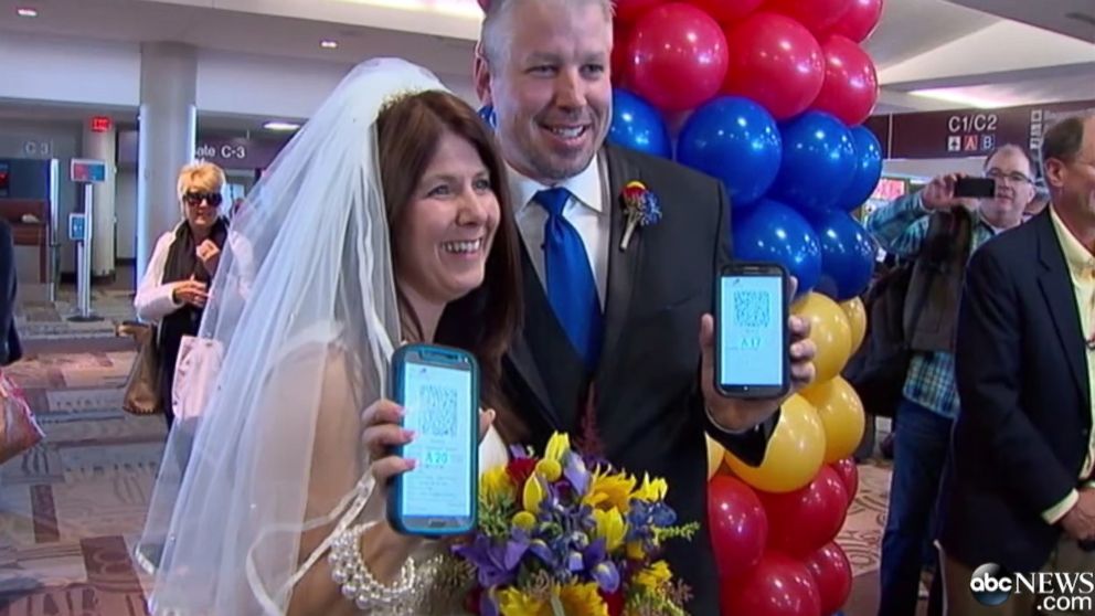Dottie Coven and Keith Stewart read vows from their mobile phones.