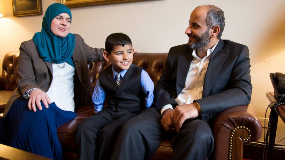 PHOTO: Ahmad Alkhalaf, 9, sits with his father and Nadia Alawa, executive director at NuDay Syria, left.
