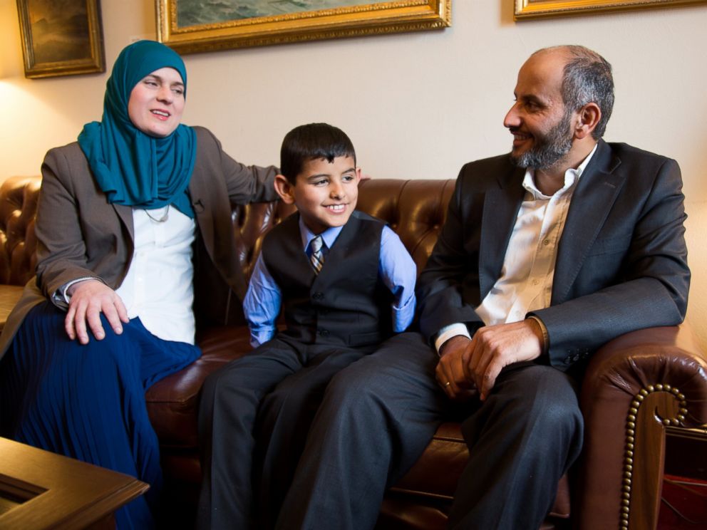 PHOTO: Ahmad Alkhalaf, 9, sits with his father and Nadia Alawa, executive director at NuDay Syria, left.