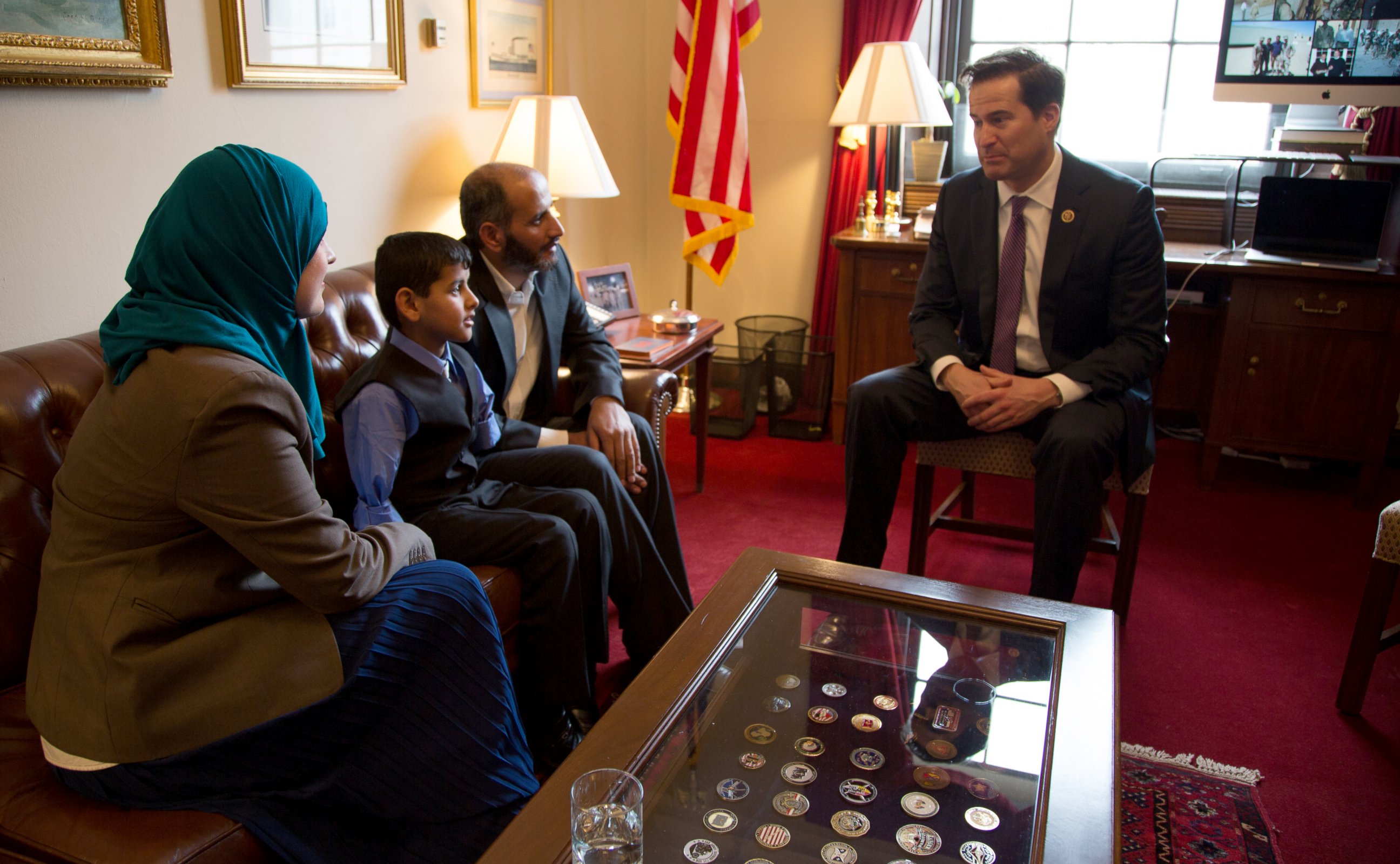 PHOTO: Ahmad Alkhalaf, 9, sits with his father, center right, Nadia Alawa, executive director at NuDay Syria, and Congressman Seth Moulton. 