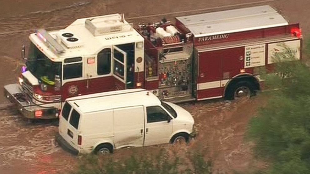 PHOTO: Arizona firefighters navigated through a flooded roadway this morning to rescue a stranded motorist. 