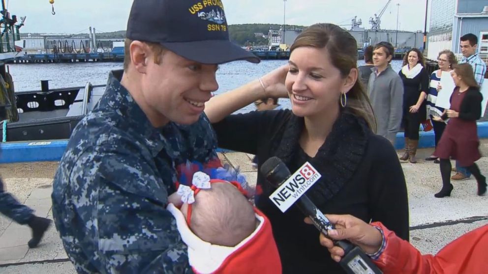 PHOTO: Returning service member Eric Gatchell met his first child, a daughter named Grace, for the first time.