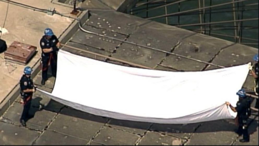 The NYPD take down white flags that appeared over the Brooklyn Bridge on July 22, 2014.