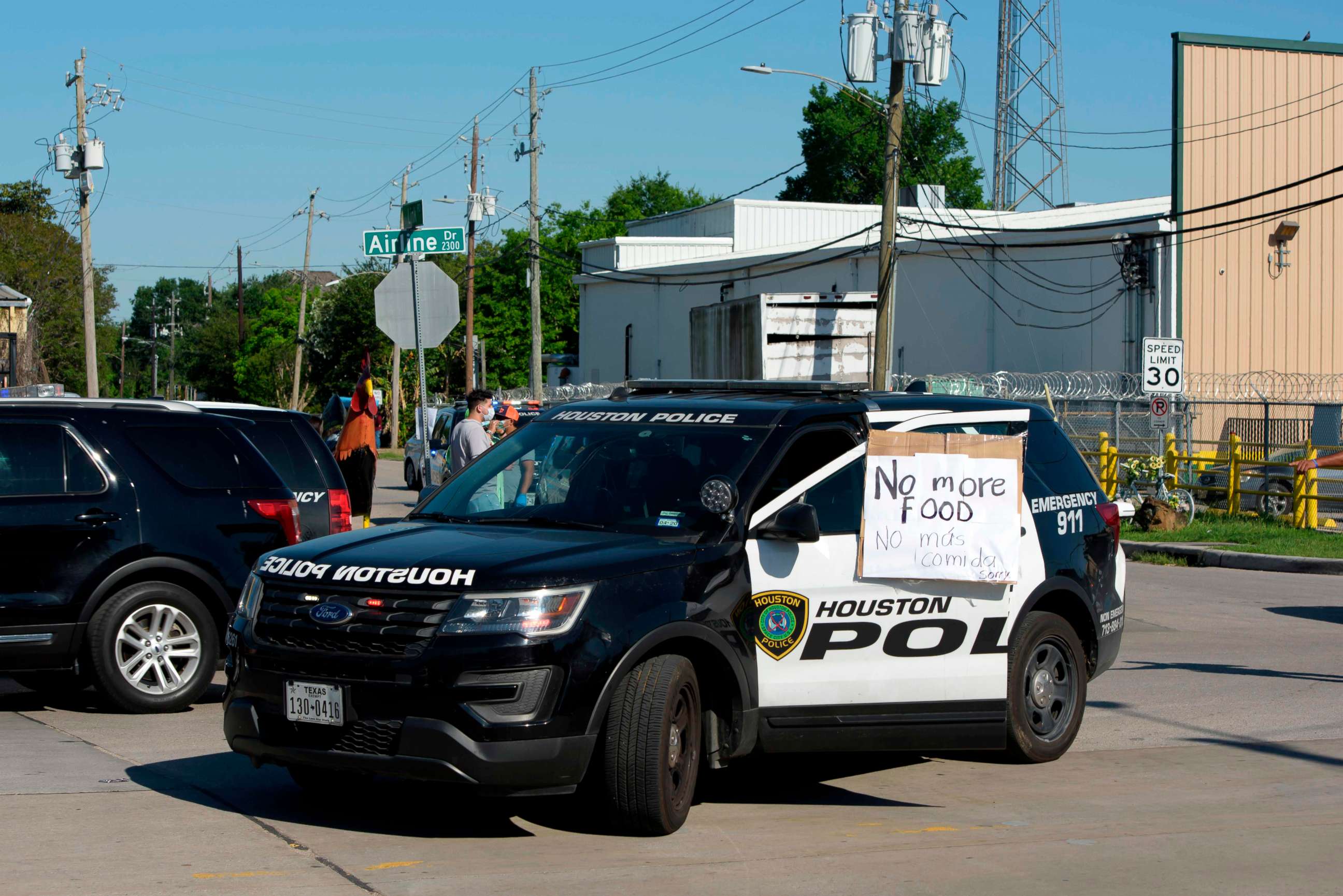 PHOTO: A sign on a police car lets passerby's know that there's no more food left a food distribution site at Reyes Produce April 13, 2020 in Houston, Texas. 