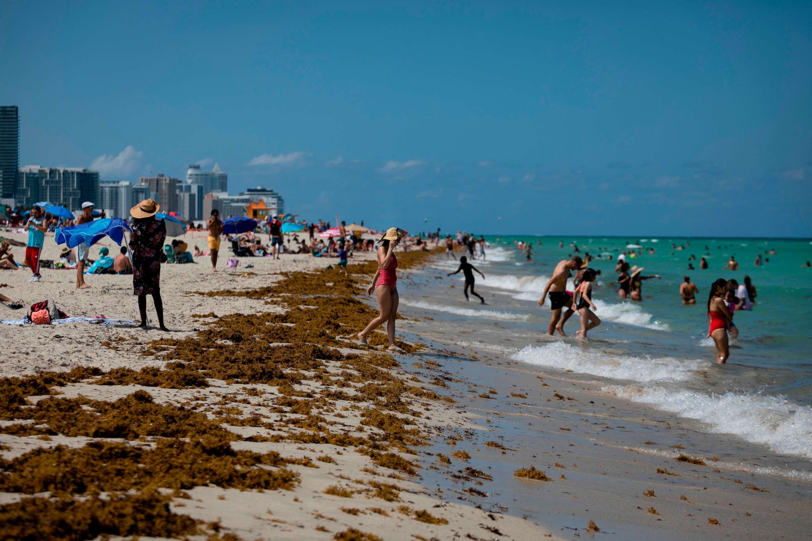 PHOTO: People gather on the beach in Miami Beach, Florida on June 16, 2020. - Florida is reporting record daily totals of new coronavirus cases, but you'd never know it looking at the Sunshine State's increasingly busy beaches and hotels. 
