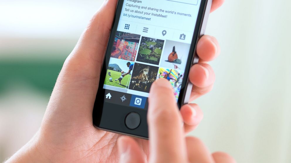 A woman is seen using Instagram on her cell phone in this undated file photo.